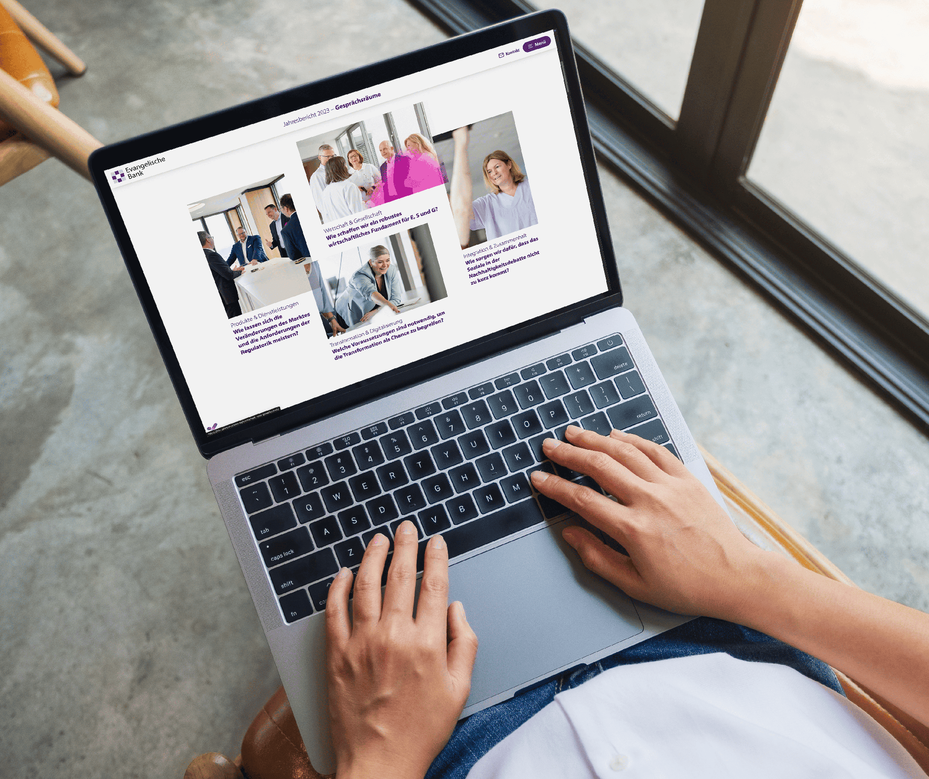Person uses laptop to view the Evangelische Bank's digital annual report - modern, accessible web design for business communication.